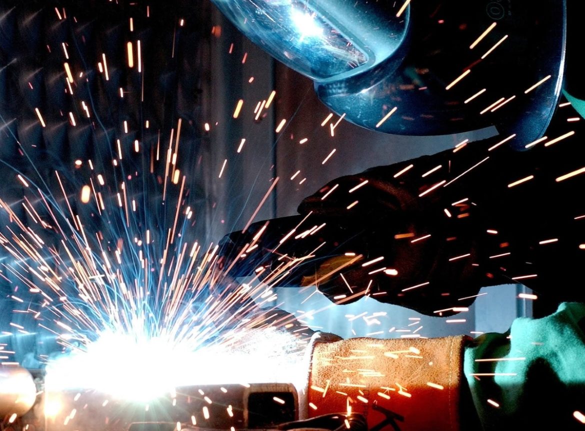 A person in a mask welding.