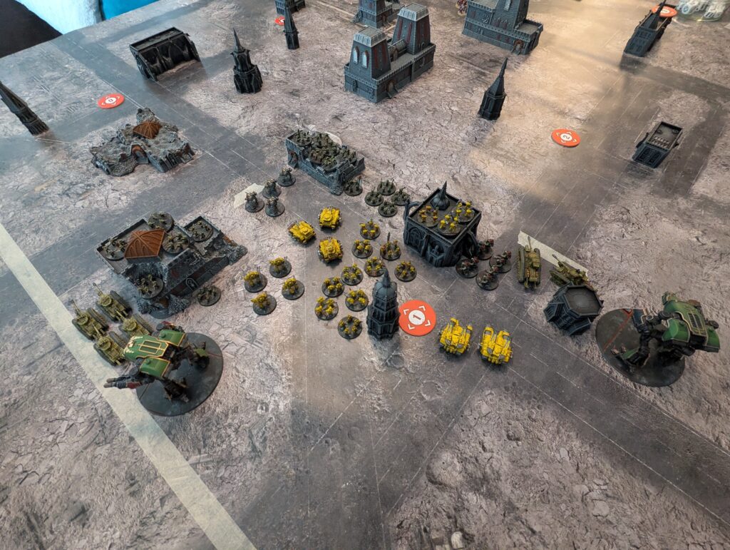 Imperial Fists and their Solar Auxilia allies deployed in one corner of the table, clustered around objective 1 and a series of buildings. 