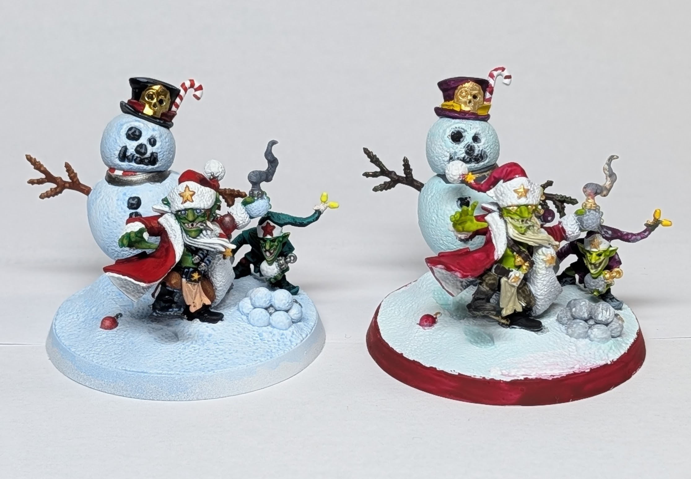 Our painted models side-by-side. We have both stayed close-ish to the studio colour choices, although my partner went for a purple outfit for the small goblin. 