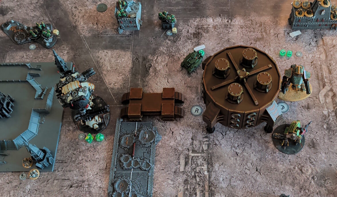 Overhead shot of the battlefield, with the central building, Warmaster and Reaver titans all visible.