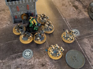 Assault Marines and Ogryn swarm a Saturnine Dreadnought.